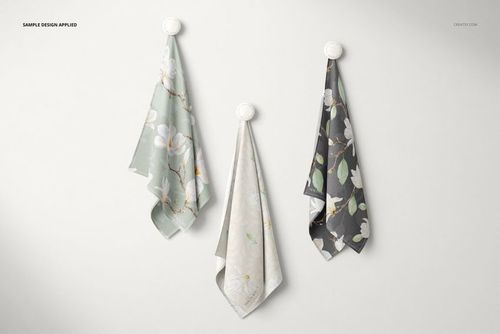 PSD mockup featuring three draped textiles with flower designs, each hanging separately against a plain white wall.