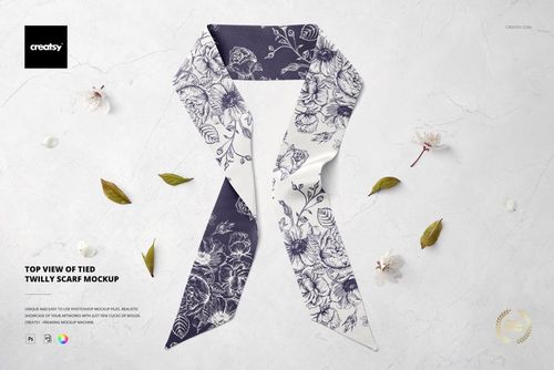 Top view of a twilly scarf mockup with a floral pattern, displayed on a marble surface with scattered leaves and flowers.