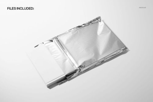 PSD mockup featuring a hardback book half exposed from a reflective metallic pouch, minimalistic white backdrop.