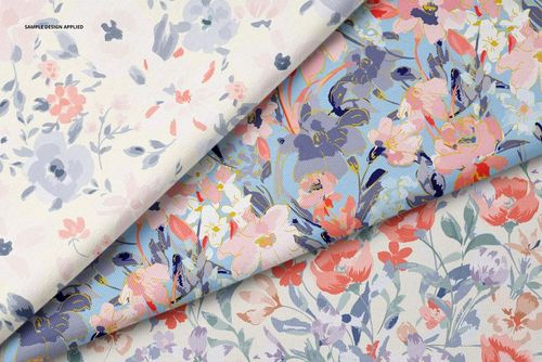 PSD mockup displaying three jersey fabric samples with delicate flower motifs in blue, pink, and coral tones.