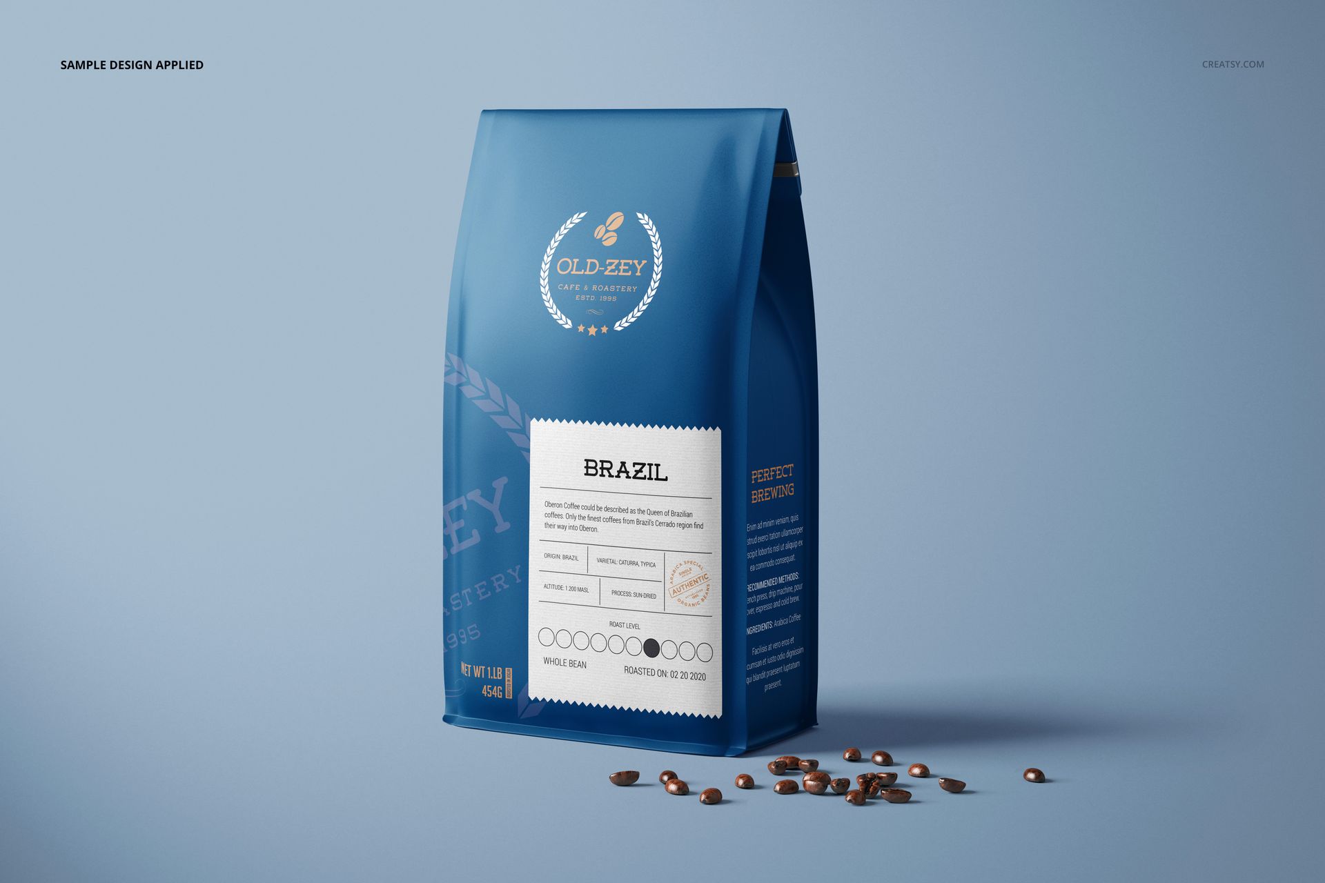 Blue paper coffee bag mockup shown upright with coffee beans around, featuring a detailed product label on the front.