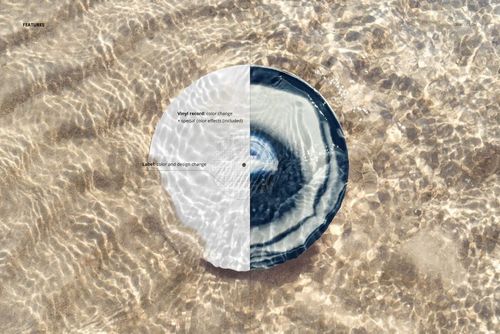 Vinyl record mockup lying on sand beneath clear water, showing reflections and gentle wave textures on the surface.