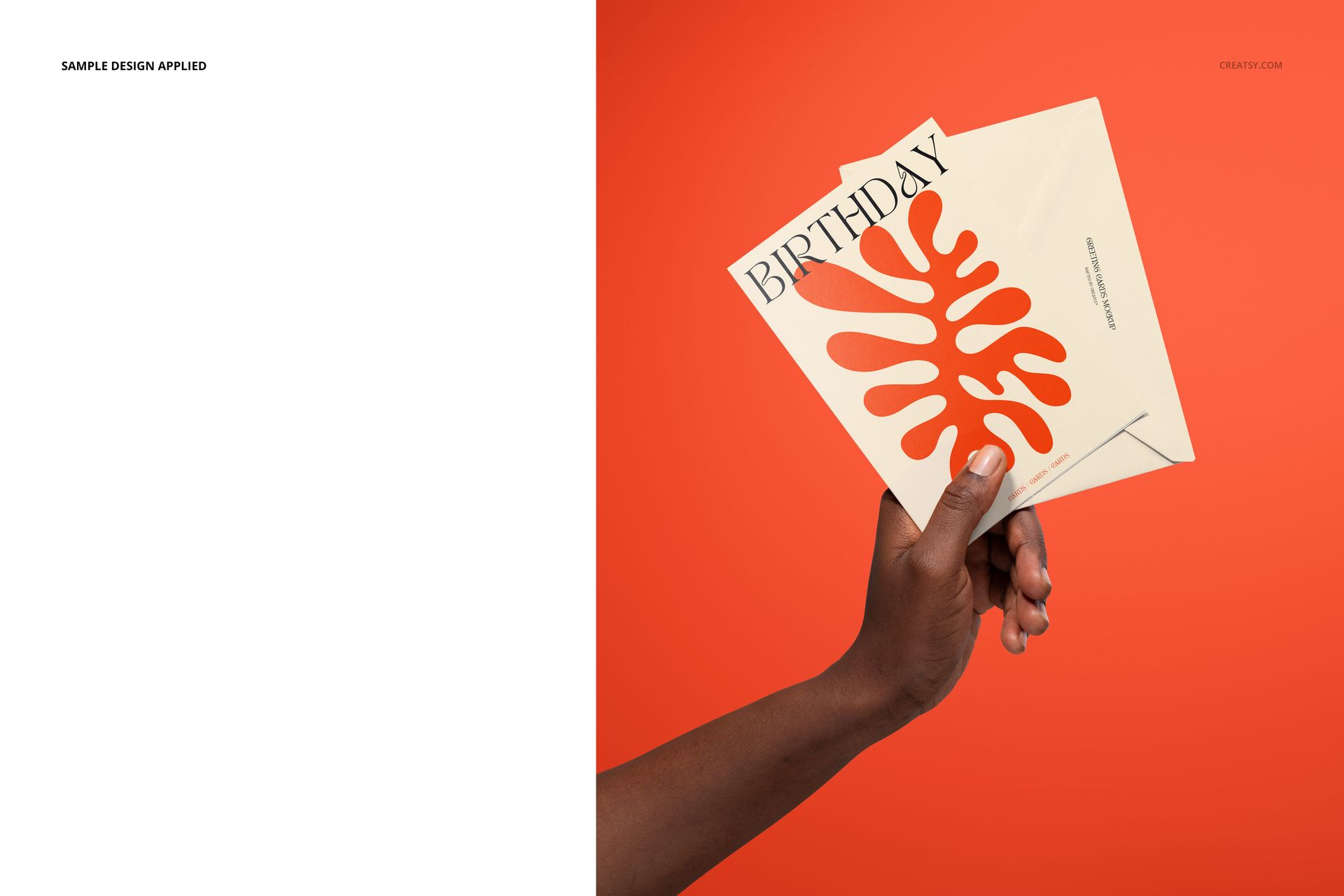 PSD mockup showing a hand displaying two 5x7 stationery cards with minimal designs against a solid orange background.