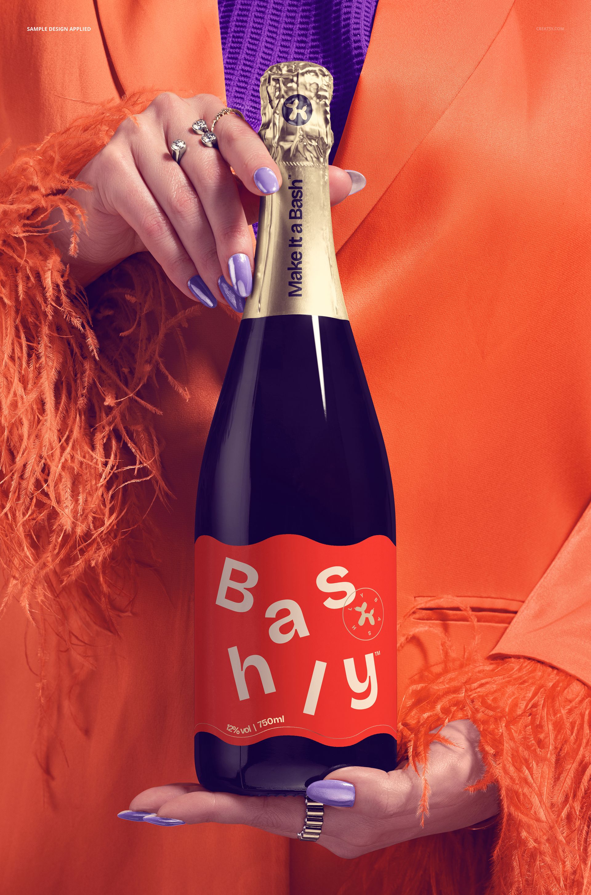 Front view of a champagne bottle mockup gripped by hands wearing an orange feathered jacket and purple top.