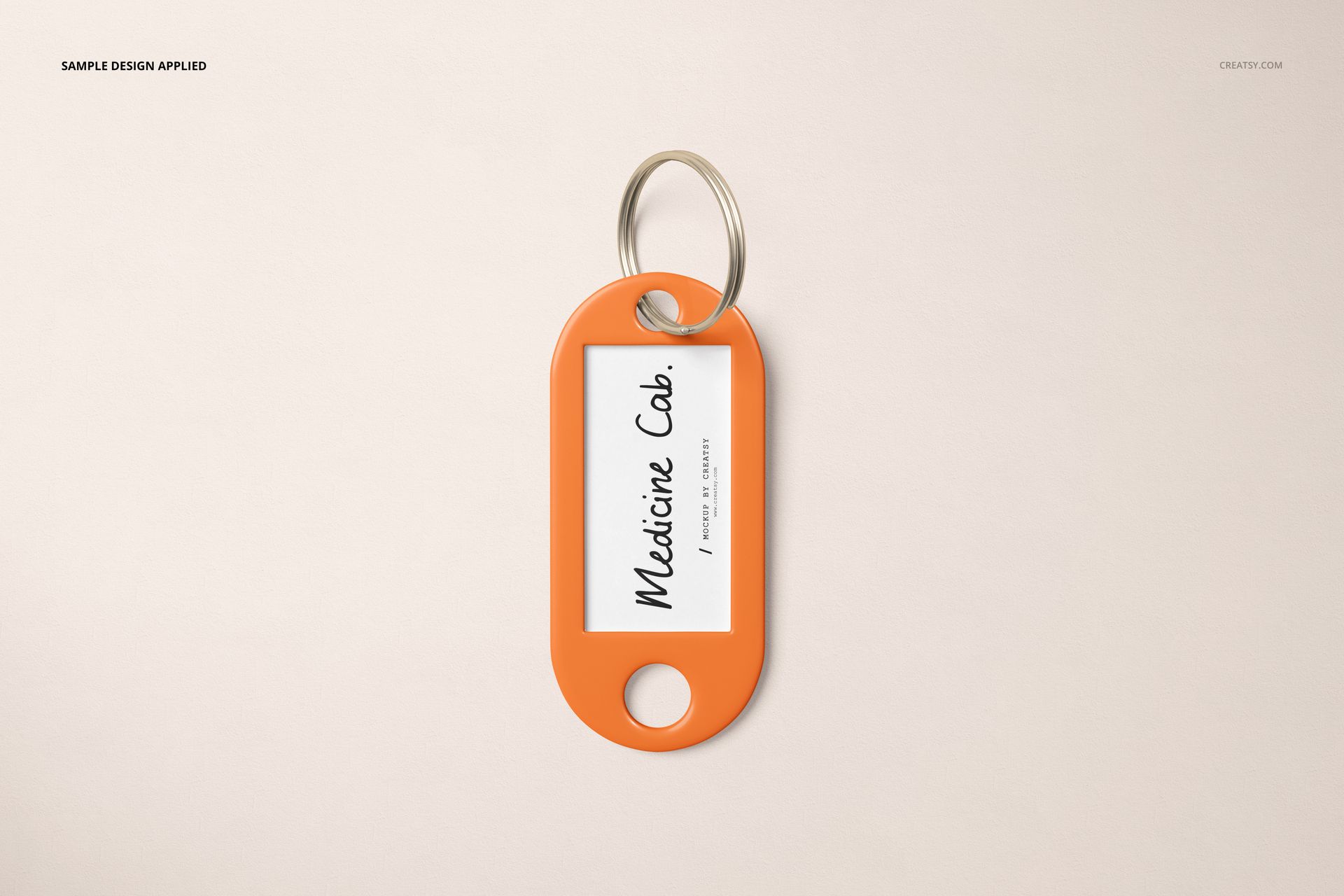 Single key tag mockup with orange edges and silver key ring, displaying a rectangular white label in the center.