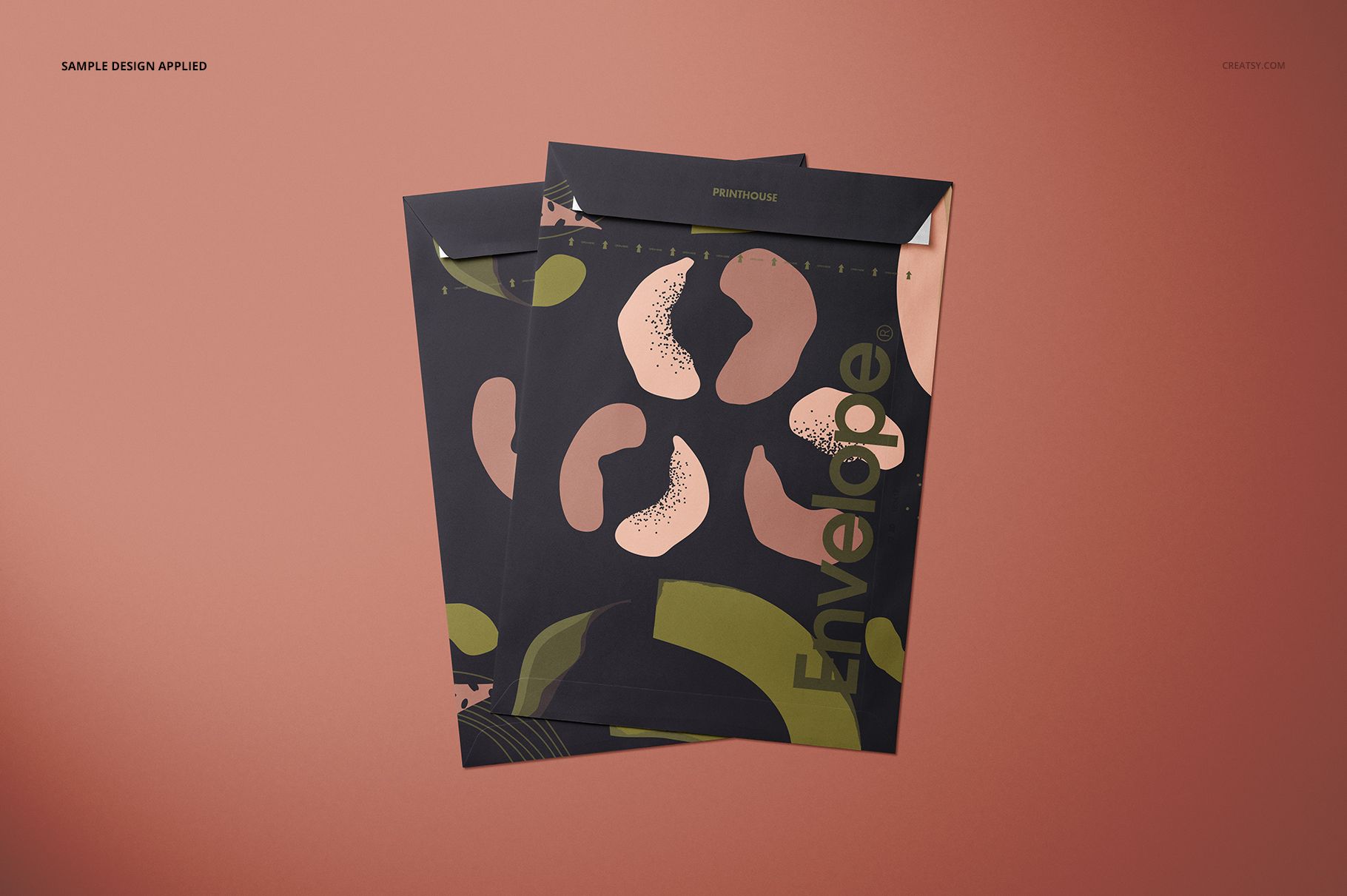 Envelope mockup set featuring two mailers with bold, organic shapes in green, pink, and black on a brown background.