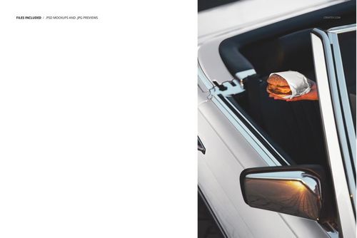PSD mockup showing a burger in hand with packaging, arm extended from a classic convertible vehicle, outdoor lighting.
