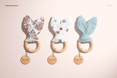 Wooden baby teether mockup set featuring three round rings with soft fabric ears in different colors and prints.