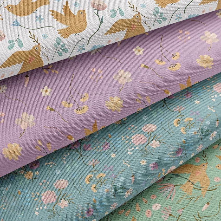 Stacked twill silk fabric mockup featuring detailed floral prints and bird motifs in soft pink, blue, and white tones.