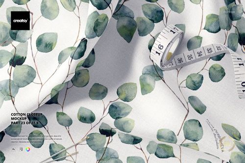 Cotton fabric mockup featuring a close-up view of leafy green branch pattern with a measuring tape on top.