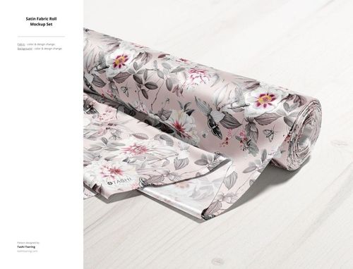 PSD mockup of a satin fabric roll featuring a detailed botanical print in muted pink and gray, shown from a side angle.