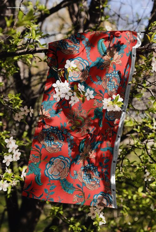 PSD mockup showing a decorative fabric with intricate flower motifs displayed on a tree branch in a natural setting.