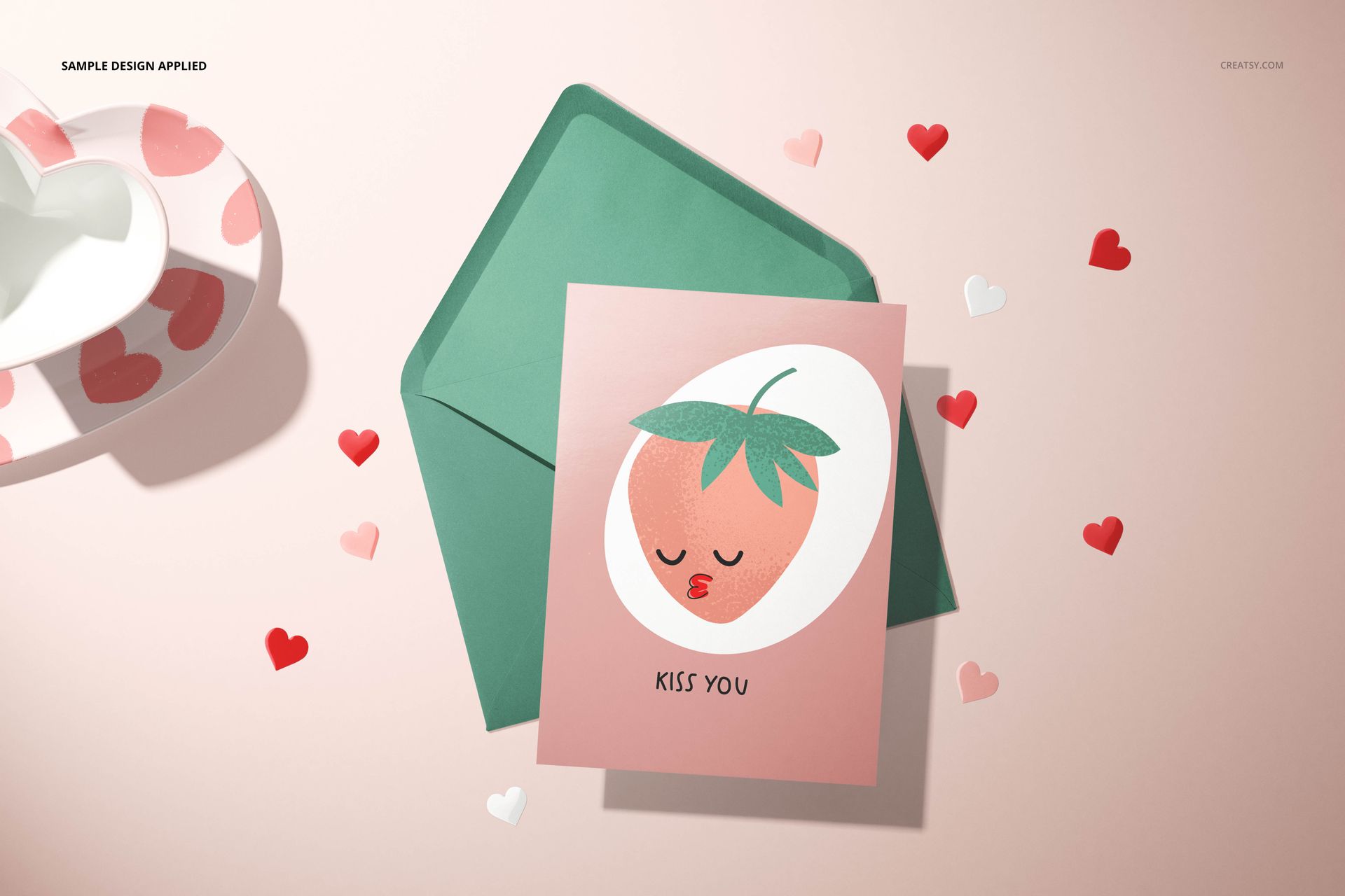 Paper Valentines card mockup featuring a pink card with strawberry artwork, green envelope, and heart-shaped confetti.