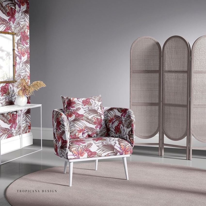 Armchair mockup in a sitting corner, featuring a floral seamless pattern on the chair and wall, with a neutral rug and room divider.