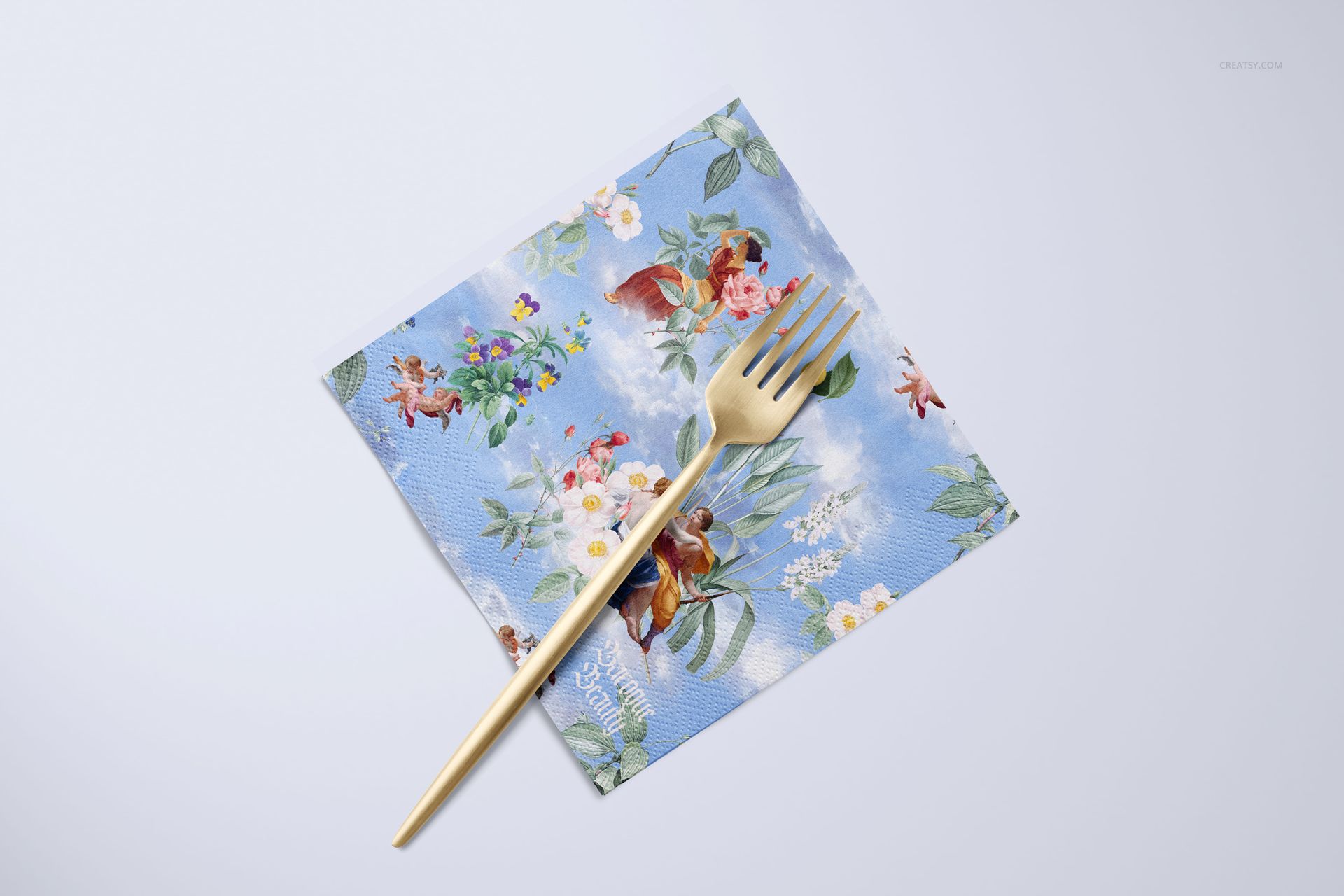 Square napkin with a blue floral pattern and gold fork on top, displayed on a light background in a mockup scene.