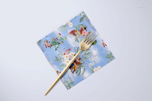 Square napkin with a blue floral pattern and gold fork on top, displayed on a light background in a mockup scene.