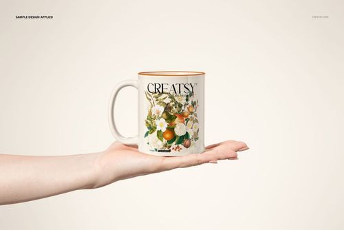 Front view of a sublimation coffee mug mockup featuring a botanical design, balanced on an outstretched hand.