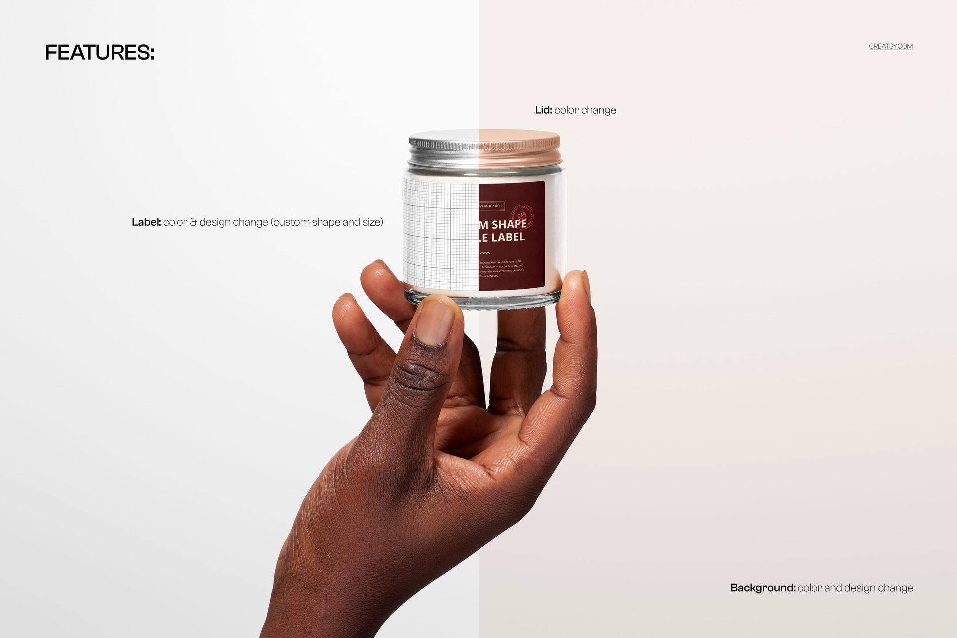 PSD mockup of a clear glass candle jar with silver lid, custom label, and hand, set against a divided pale backdrop.