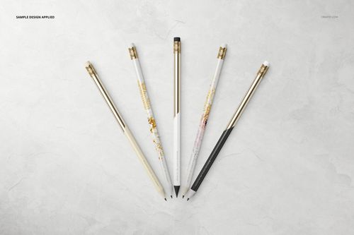 Stationery mockup featuring five pencils with metallic details, displayed in a spread on a marble-like background.