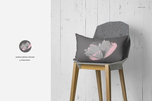 PSD mockup showing a rectangular pillow with a soft floral pattern resting on a wooden chair in a minimalist room.