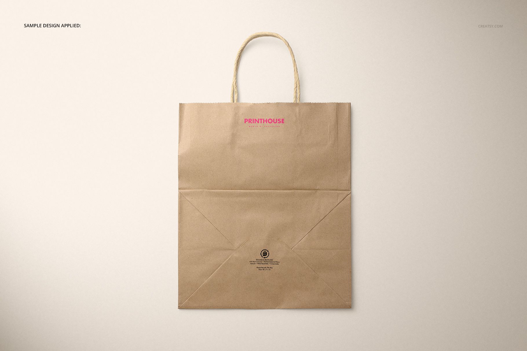 Back view of a brown kraft paper shopping bag mockup with rope handles, placed on a light surface.