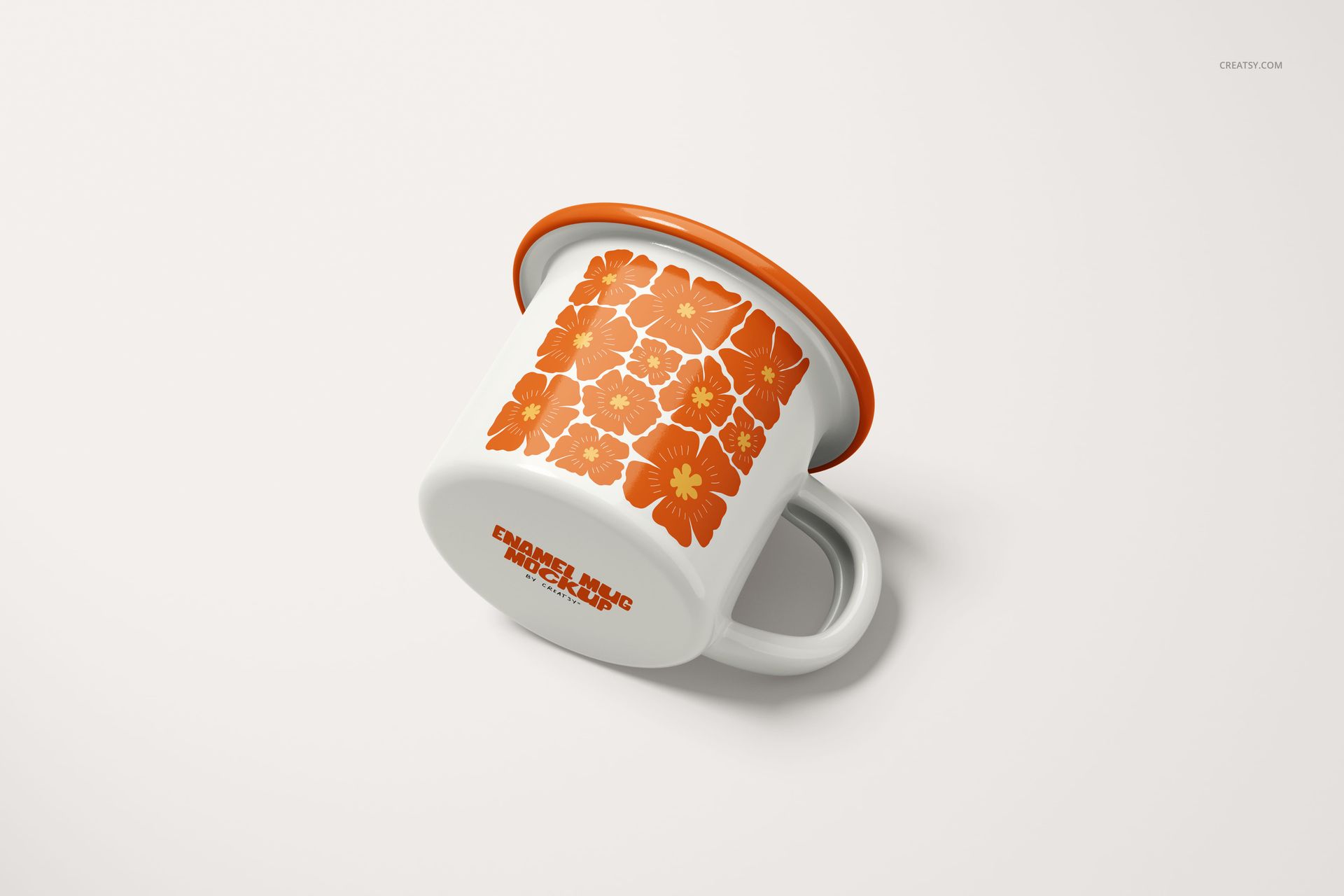 White enamel mug with orange floral pattern, orange rim, and handle, shown at an angle on a plain background.