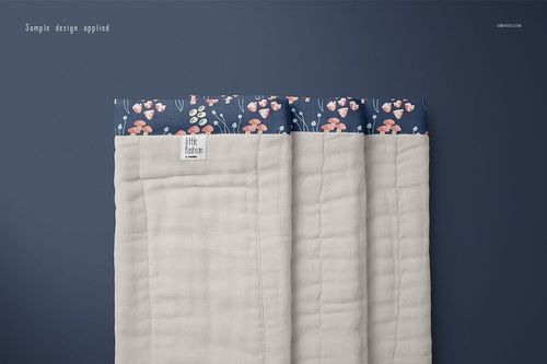 Burp cloth mockup featuring a folded beige cloth with a patterned blue top edge, shown from a top view on a blue background.