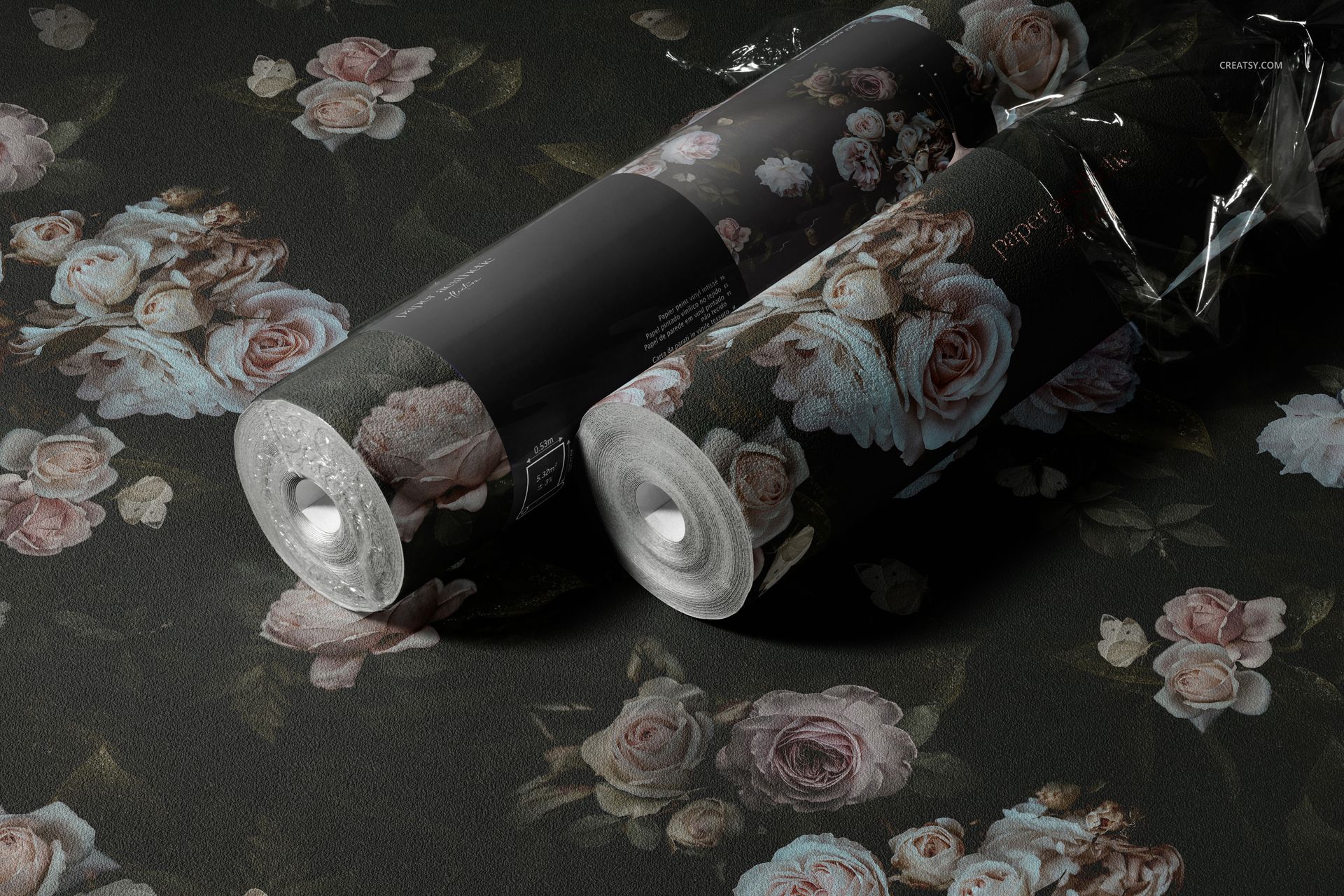 Two non-woven vinyl wallpaper rolls with a floral pattern on a dark background, displayed in a realistic mockup scene.