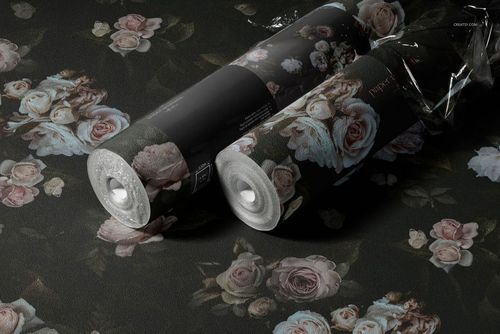 Two non-woven vinyl wallpaper rolls with a floral pattern on a dark background, displayed in a realistic mockup scene.