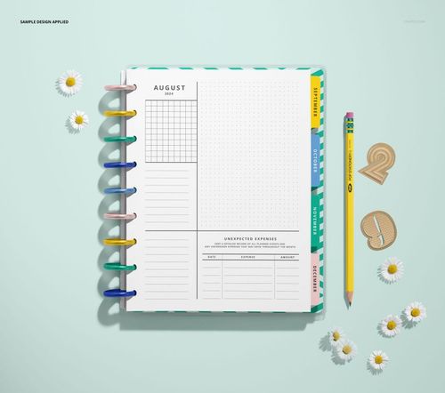 Top view of an open spiral planner mockup featuring patterned dividers, a pencil, and decorative daisies on a pastel background.