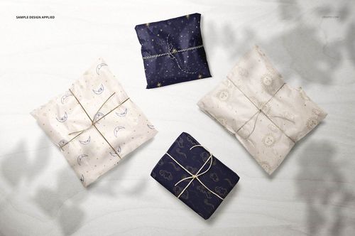Gift wrapping tissue paper mockup showing assorted packages in blue and cream, decorated with celestial designs and string.