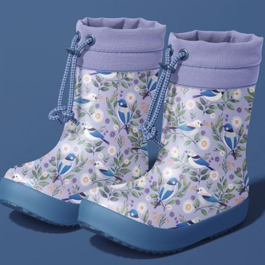 Rain boots mockup featuring a pair of children's boots with a colorful bird and floral pattern on a blue background.