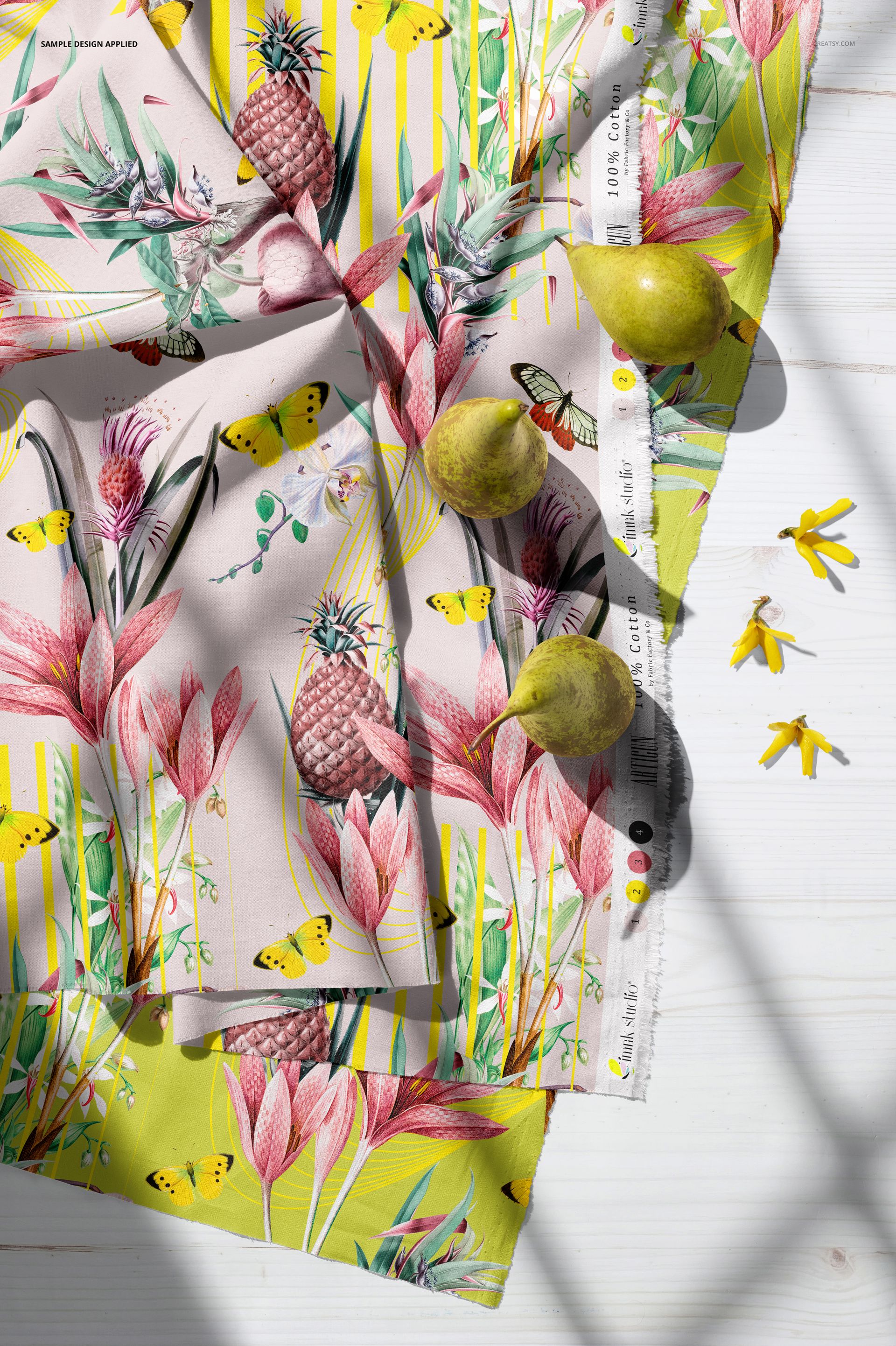 Cotton fabrics mockup featuring tropical floral and butterfly patterns in pink and yellow, shown from a top view.