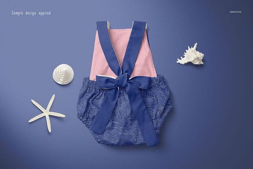Baby romper mockup displayed from top view on a blue surface, featuring pink top and blue patterned bottom with bow.