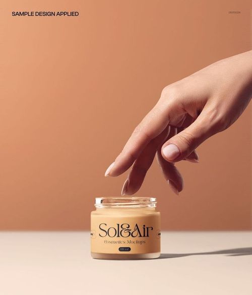 Open glass cosmetic jar with beige cream, front view, hand reaching in, neutral background, PSD mockup.