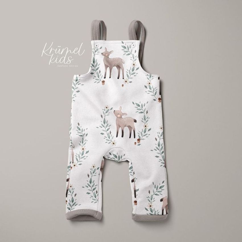 Kids fleece dungarees mockup featuring a white garment with a deer and foliage pattern, displayed on a neutral background.