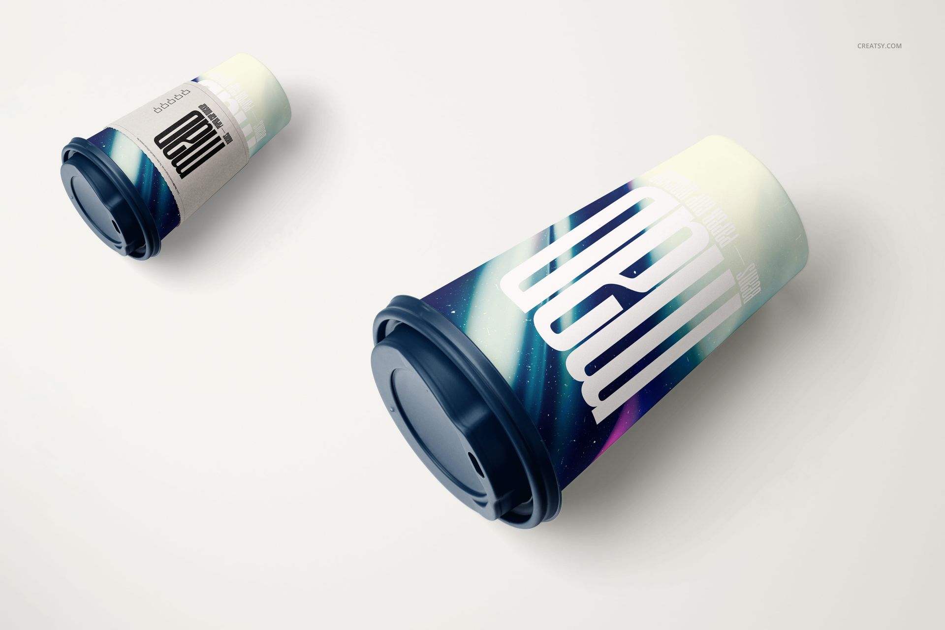 Paper coffee cup PSD mockup set featuring two cups, one with a removable sleeve, shown from a diagonal perspective.