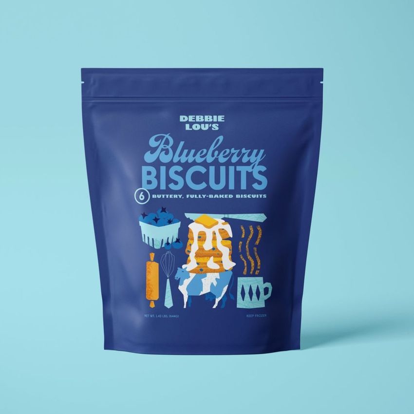 Stand up zip lock pouch mockup featuring a blue resealable bag with colorful blueberry biscuit illustrations and bold printed text.