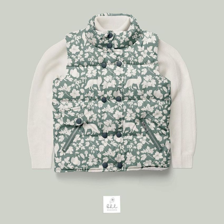 Boys winter set mockup featuring a patterned puffer vest with animal and leaf motifs over a cream long-sleeve shirt on a light gray background.