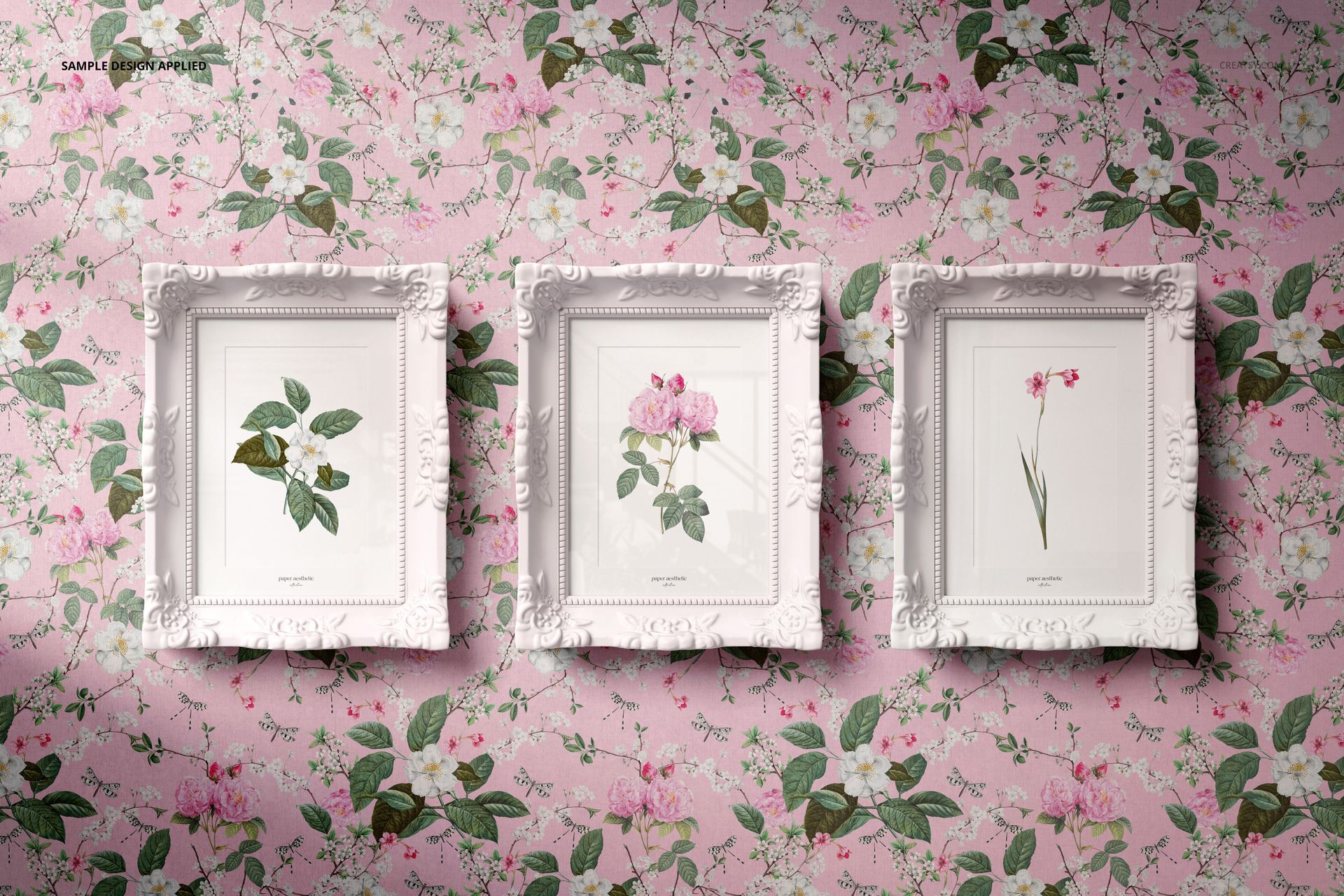 PSD mockup showing three decorative white frames with plant illustrations, set on a pink floral background.