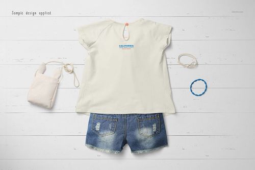 Baby summer set mockup featuring a cream short-sleeve shirt and blue denim shorts, displayed on a white wooden surface.