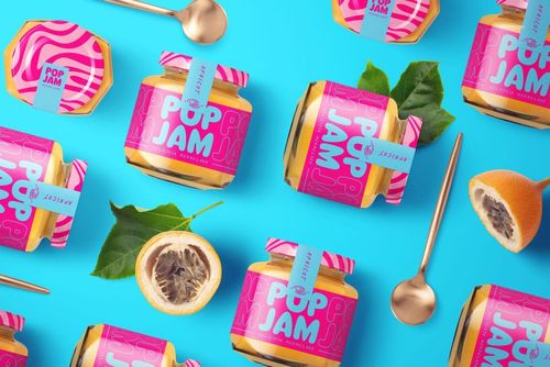 Front view of jam jar PSD mockup bundle with vivid label designs, scattered passion fruit slices, leaves, and metallic spoons.