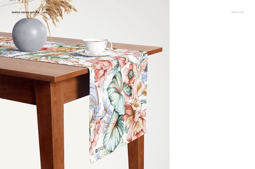 Floral table runner mockup on a rectangular wooden table, featuring pastel flowers and green leaves, front perspective.