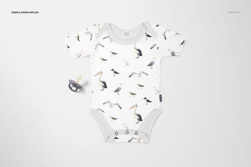 Baby onesie mockup featuring a bird print in gray and beige, laid flat beside a gray pacifier on a light surface.