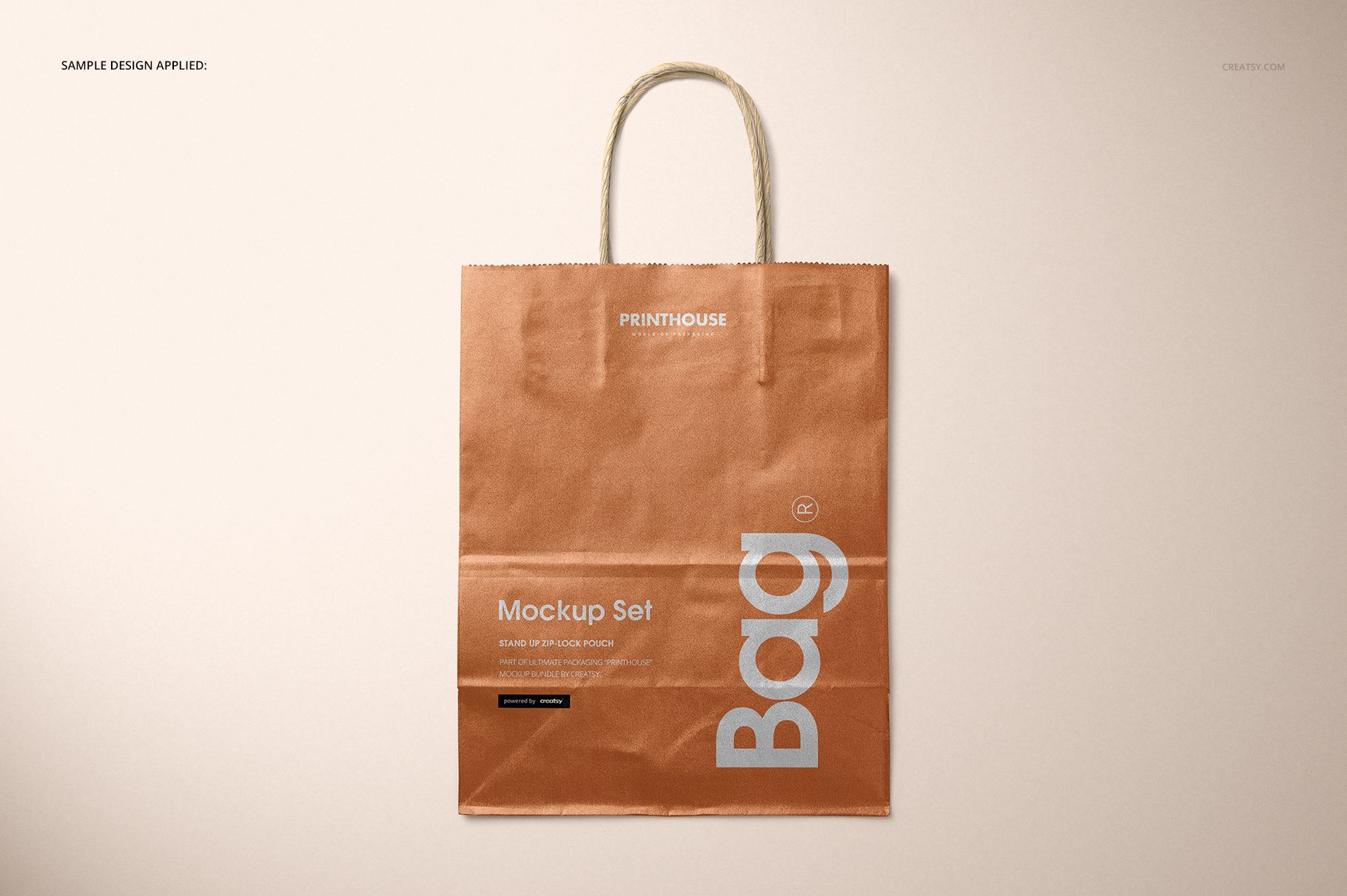 Metallic kraft paper shopping bag mockup displayed upright with rope handles and a copper-brown finish.