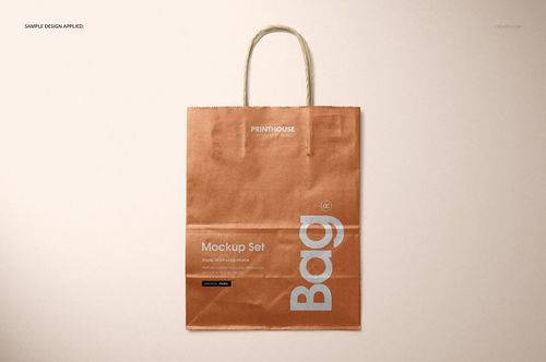 Metallic kraft paper shopping bag mockup displayed upright with rope handles and a copper-brown finish.