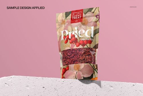 PSD mockup showing a stand up pouch featuring a botanical pattern, set on a concrete ledge with a pink backdrop.