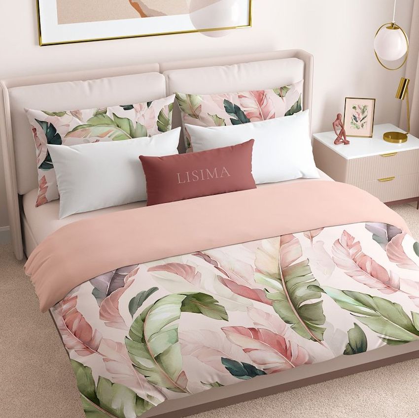Bedroom bedding mockup featuring a neatly made bed with watercolor tropical leaf patterns in soft pink, green, and beige tones.
