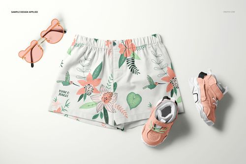 Baby and kids shorts mockup featuring a botanical print, shown from above with matching peach shoes and sunglasses.