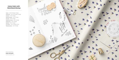 Cotton fabric mockup with scattered blue flowers, shown with sewing accessories and an open sketchbook from a top view.